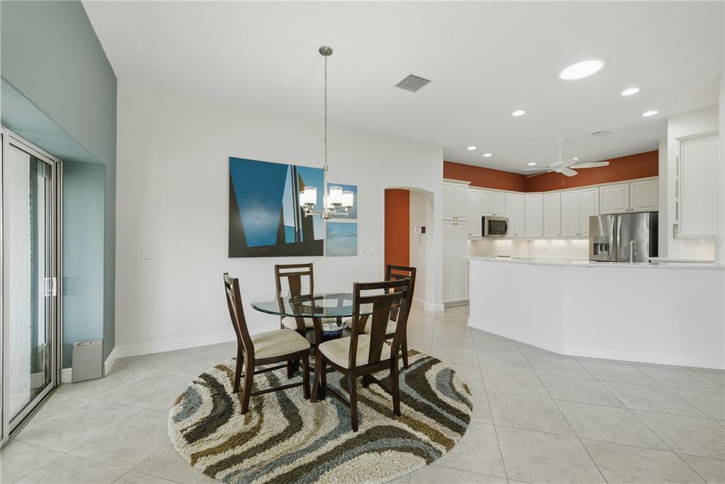 1016 Pickering Path The Villages, FL 32163 - Photo 14 of 38 a view of a dining room with furniture and wooden floor