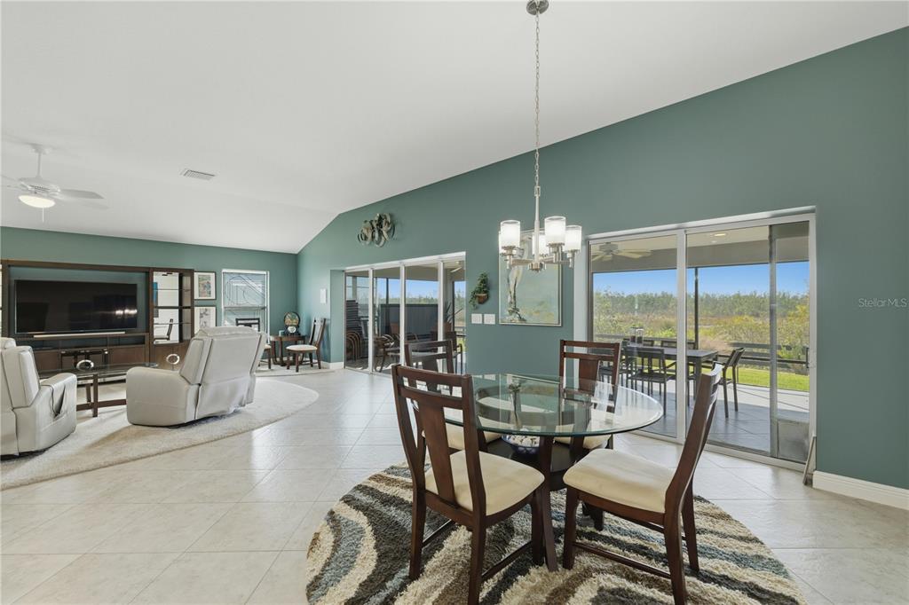 1016 Pickering Path The Villages, FL 32163 - Photo 16 of 38 a dining room with furniture a chandelier and window