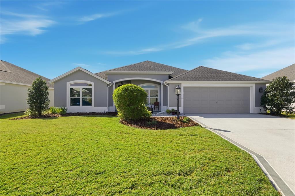 1016 Pickering Path The Villages, FL 32163 - Photo 2 of 38 a front view of a house with yard and green space