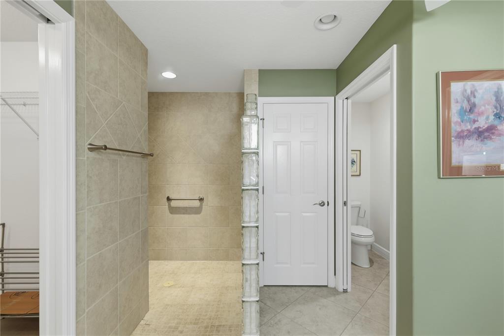 1016 Pickering Path The Villages, FL 32163 - Photo 21 of 38 a bathroom with a shower and a glass door