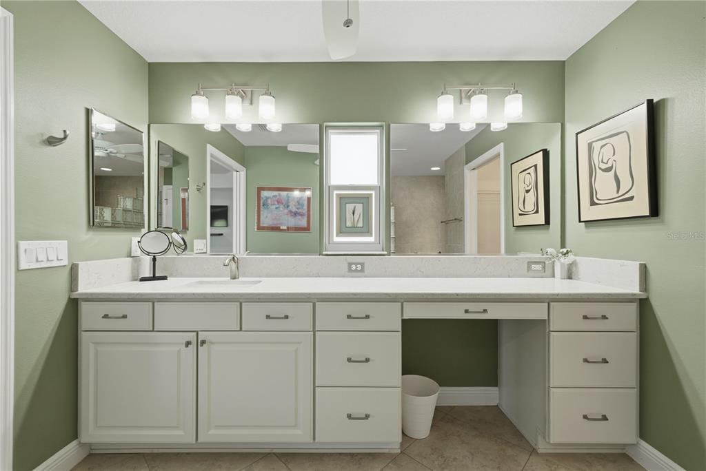 1016 Pickering Path The Villages, FL 32163 - Photo 23 of 38 a spacious bathroom with a double vanity sink double and a mirror