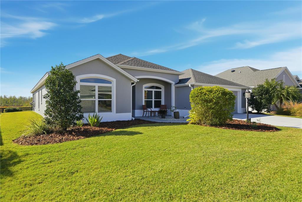 1016 Pickering Path The Villages, FL 32163 - Photo 3 of 38 a front view of a house with garden and trees