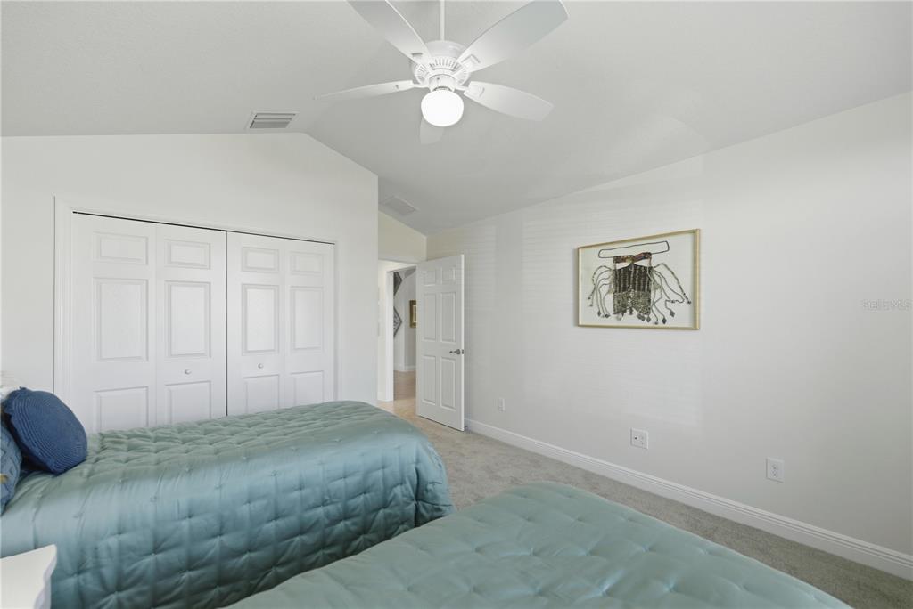 1016 Pickering Path The Villages, FL 32163 - Photo 6 of 38 a bedroom with a bed and a chandelier