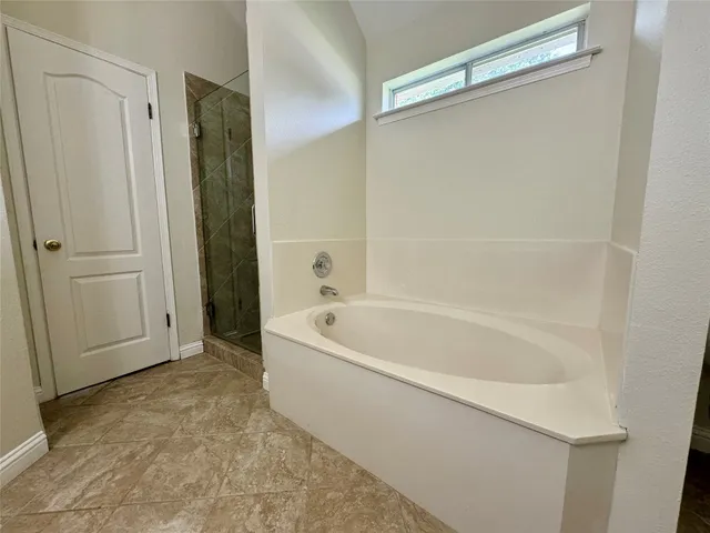a bathroom with a bathtub and a shower