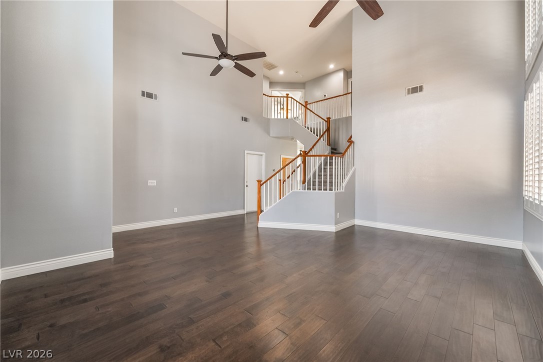 261 Timber Hollow Street Henderson, NV 89012 - Photo 7 of 51 An inviting interior boasts soaring ceilings, rich hardwood flooring, and an elegant staircase.