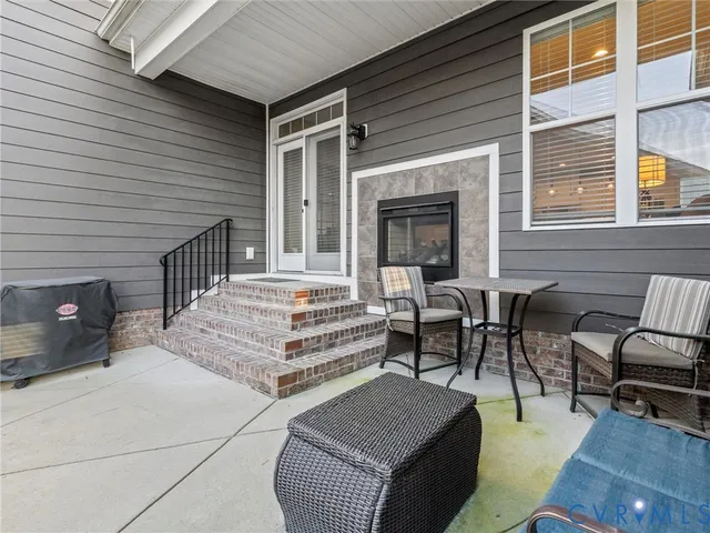 a view of a patio with table and chairs and wooden floor
