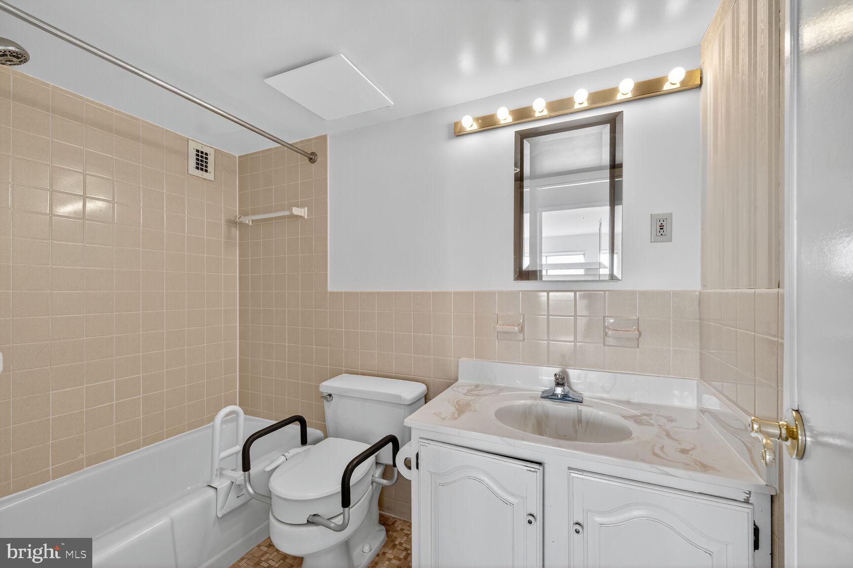 1111 University Boulevard West, Unit 1016 & 1017 Silver Spring, MD 20902 - Photo 20 of 38 a bathroom with a sink toilet and shower