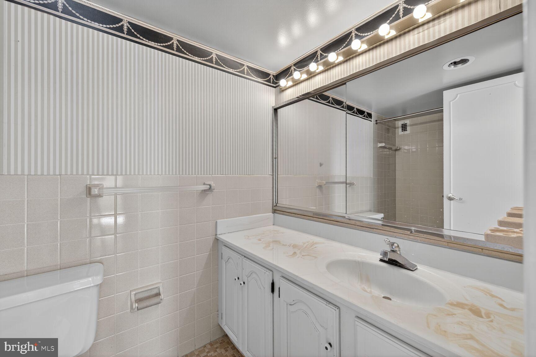 1111 University Boulevard West, Unit 1016 & 1017 Silver Spring, MD 20902 - Photo 23 of 38 a bathroom with a sink and a mirror
