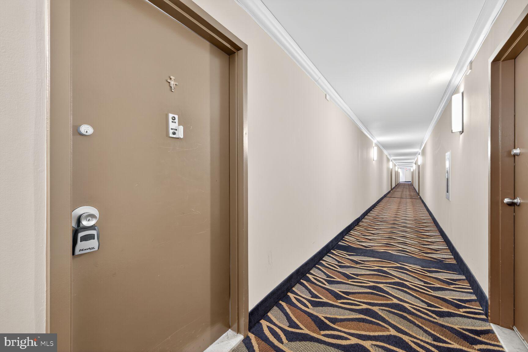 1111 University Boulevard West, Unit 1016 & 1017 Silver Spring, MD 20902 - Photo 24 of 38 a view of a hallway with wooden floor and staircase