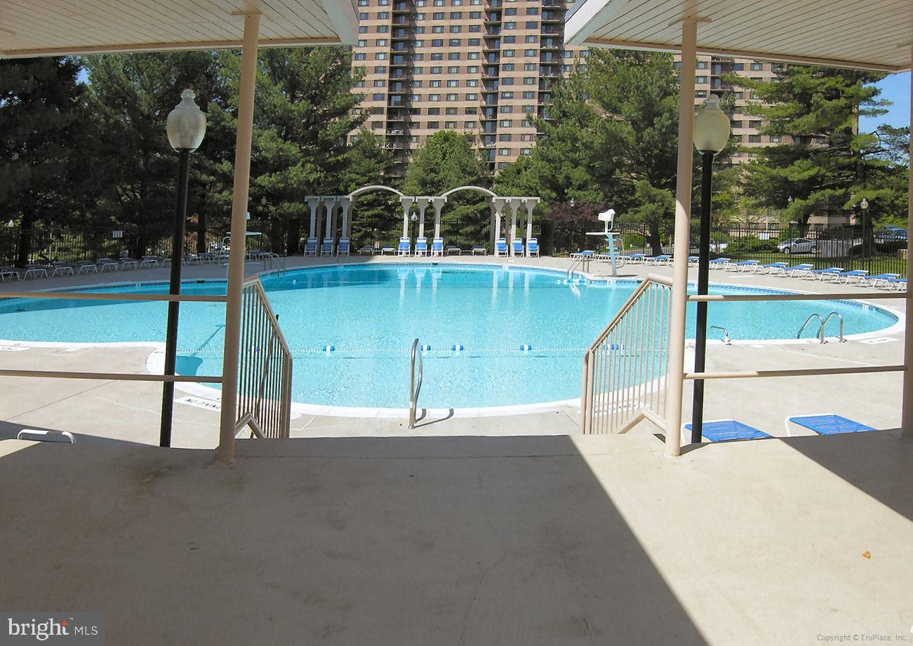 1111 University Boulevard West, Unit 1016 & 1017 Silver Spring, MD 20902 - Photo 31 of 38 a view of a swimming pool with a patio