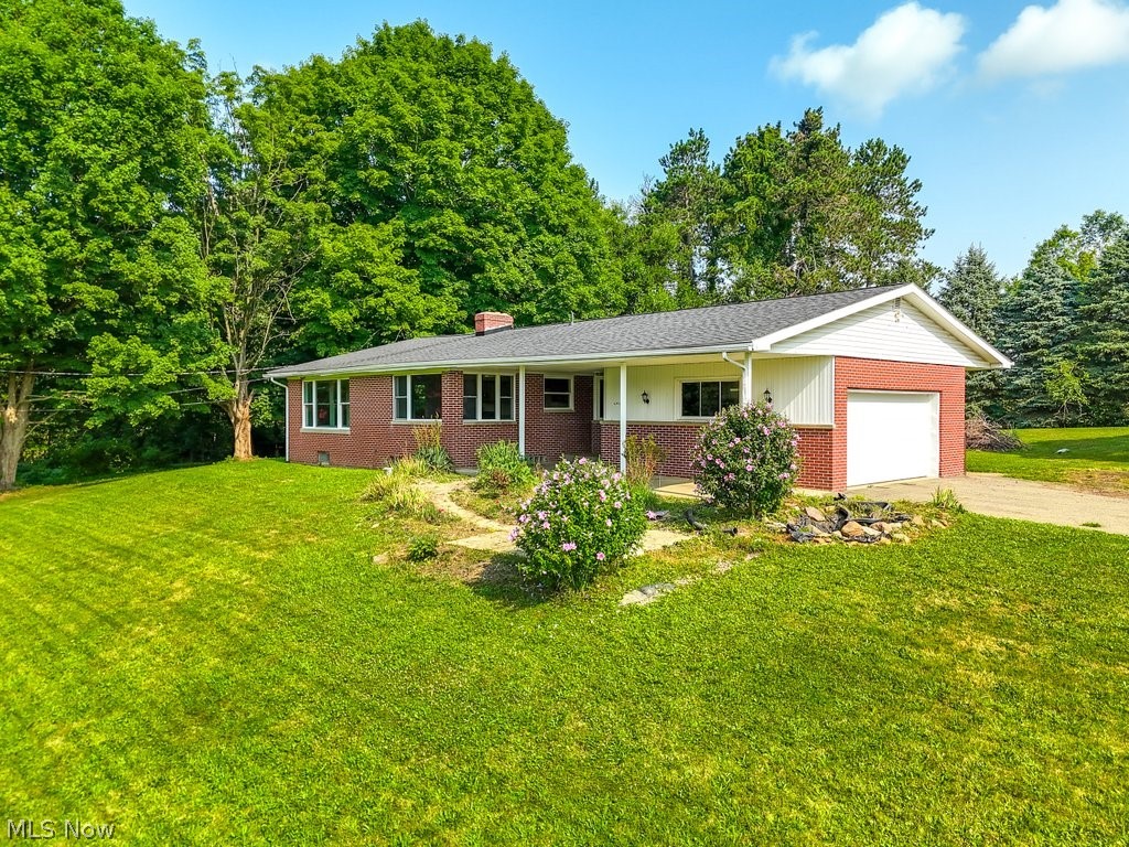 7105 Infirmary Road Ravenna, OH 44266 - Photo 1 of 33 Ranch-style home featuring a garage and a front yard