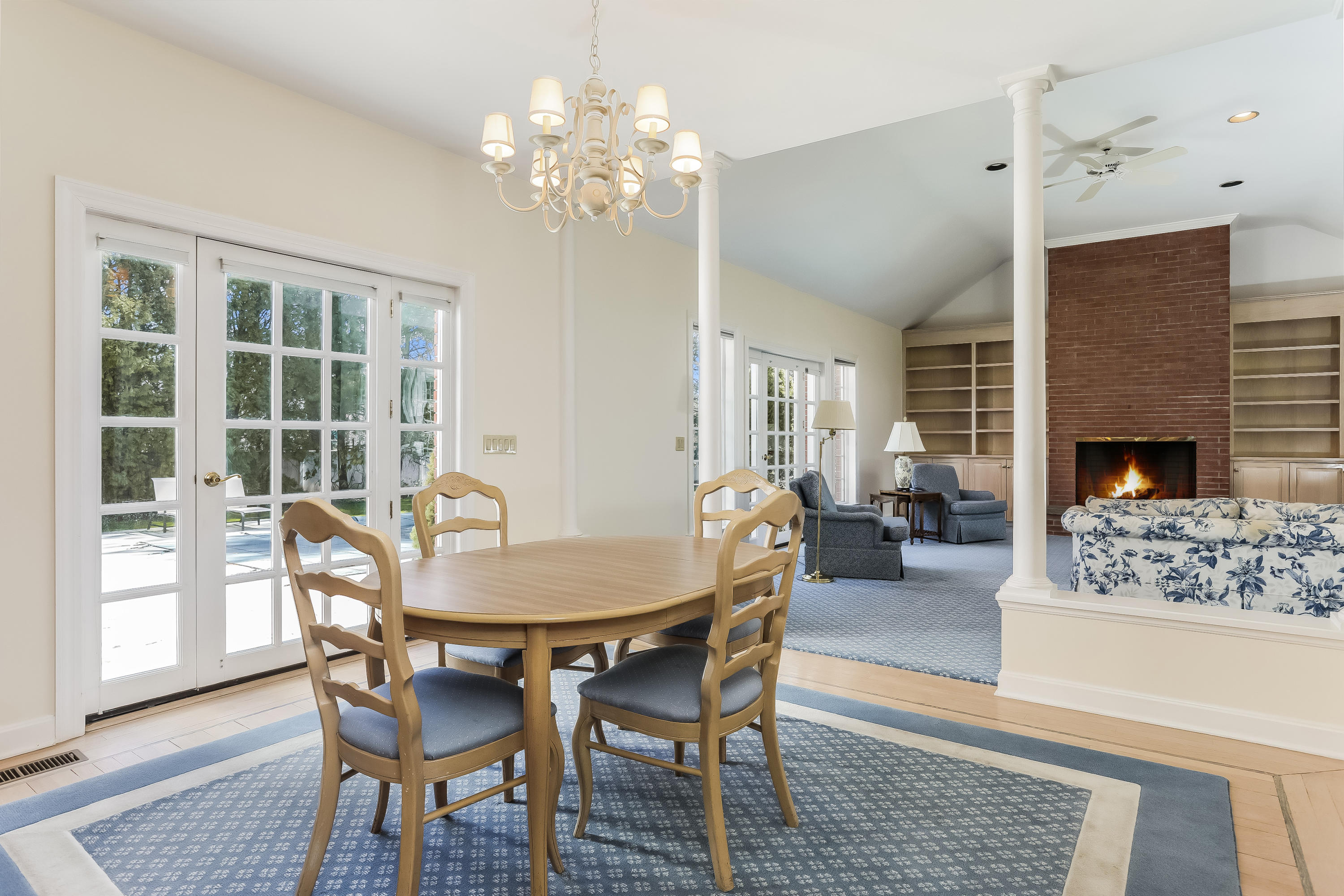 1 Shields Lane Darien, CT 06820 - Photo 13 of 41 a dining room with furniture wooden floor a chandelier and a rug