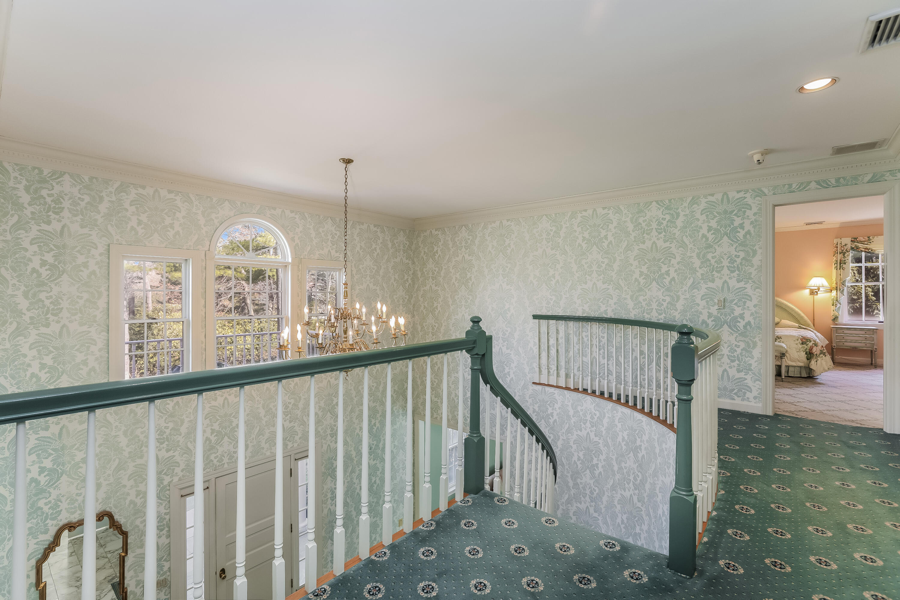 1 Shields Lane Darien, CT 06820 - Photo 18 of 41 a view of staircase with lots of frames on wall and a window