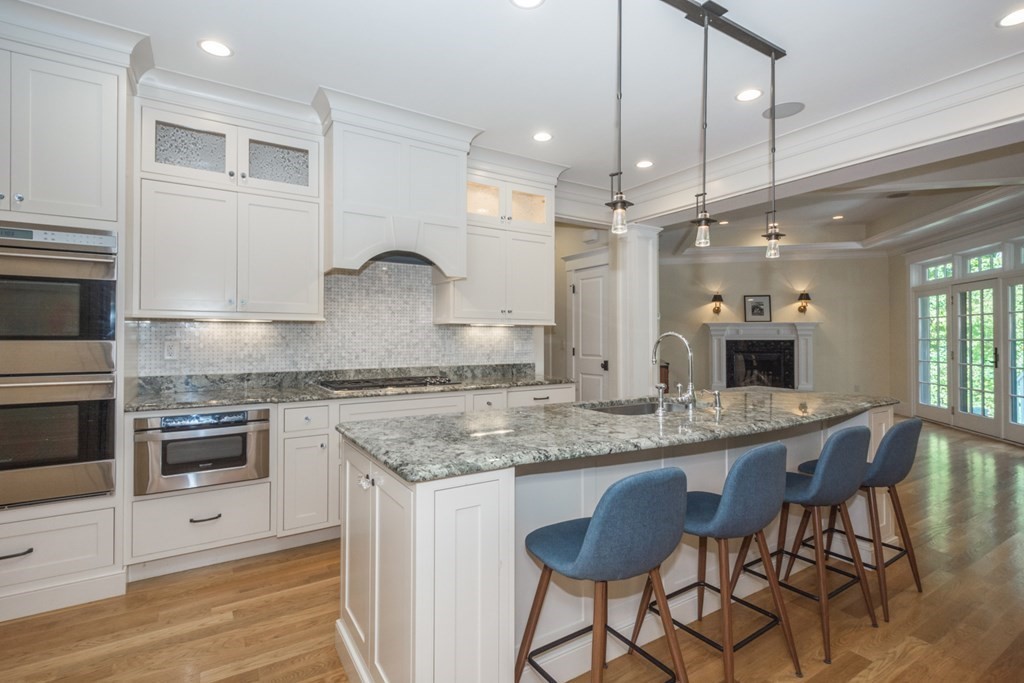 21 Sage Hill Road Wayland, MA 01778 - Photo 5 of 42 a kitchen with stainless steel appliances granite countertop a stove a sink and a refrigerator