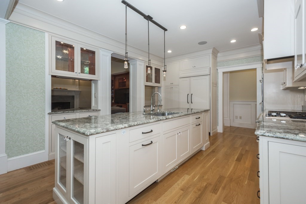 21 Sage Hill Road Wayland, MA 01778 - Photo 8 of 42 a large kitchen with a large counter top space a sink stainless steel appliances and cabinets