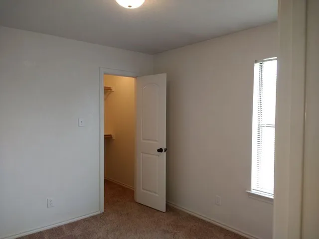 an empty room with a empty space and a window