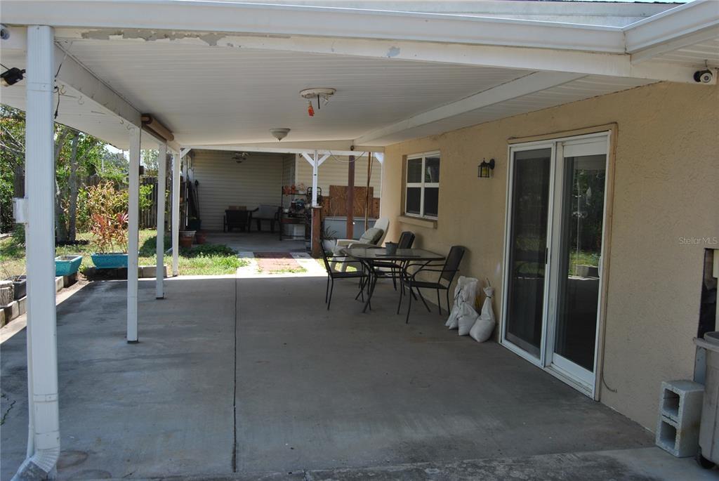 119 18th Street Northwest Ruskin, FL 33570 - Photo 16 of 20 a view of a patio with table and chairs and potted plants