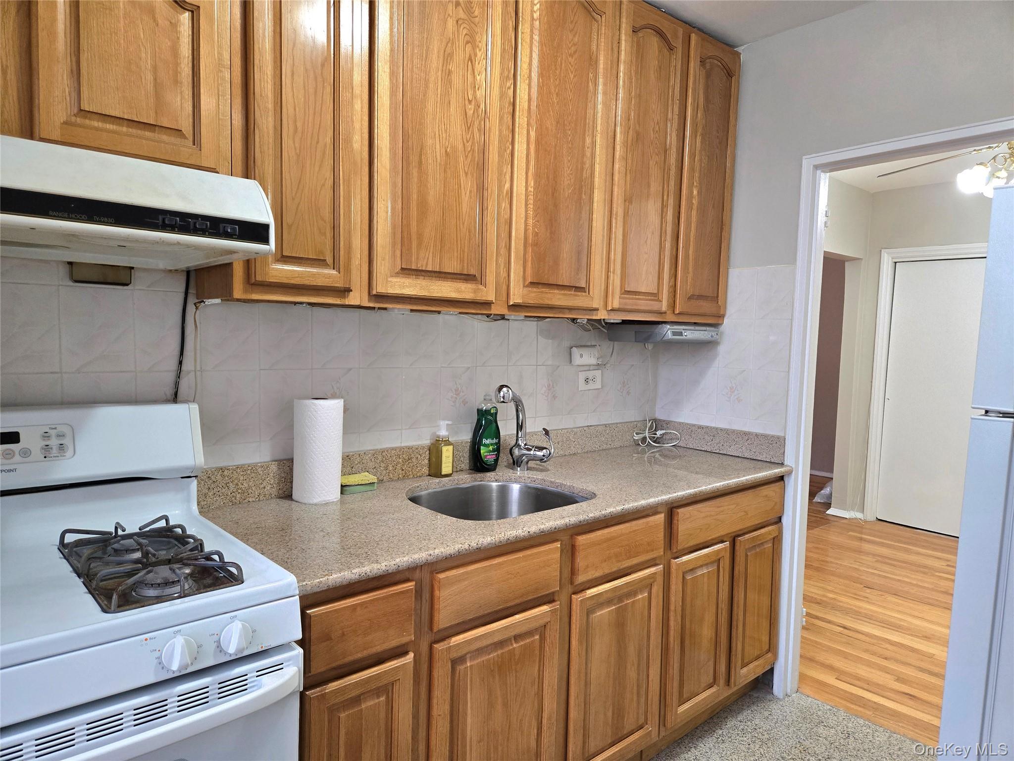 138-18 28th Road, Unit 2F Queens, NY 11354 - Photo 13 of 13 a kitchen with stainless steel appliances granite countertop a sink stove and cabinets