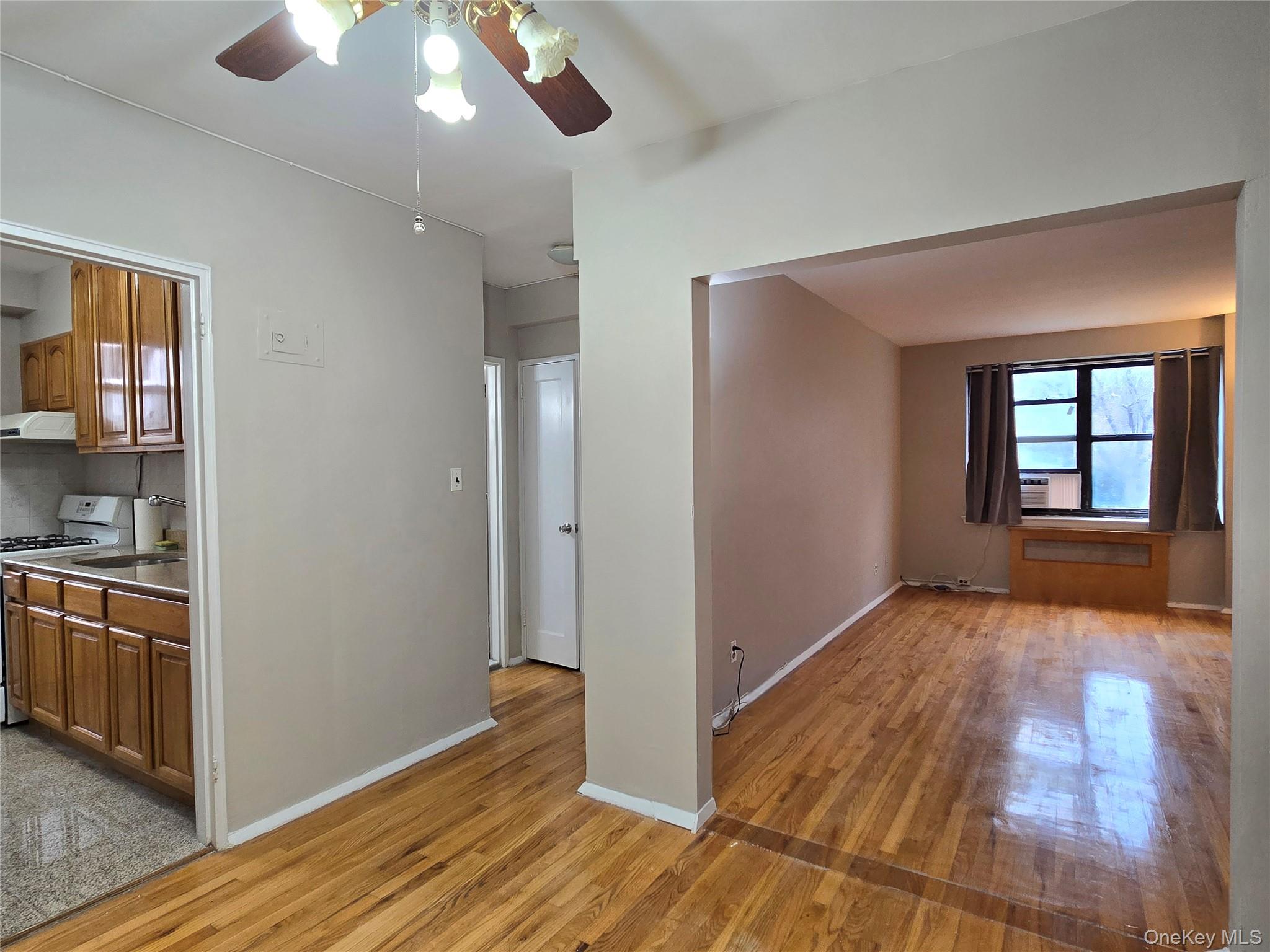 138-18 28th Road, Unit 2F Queens, NY 11354 - Photo 5 of 13 a view of an empty room with window and wooden floor