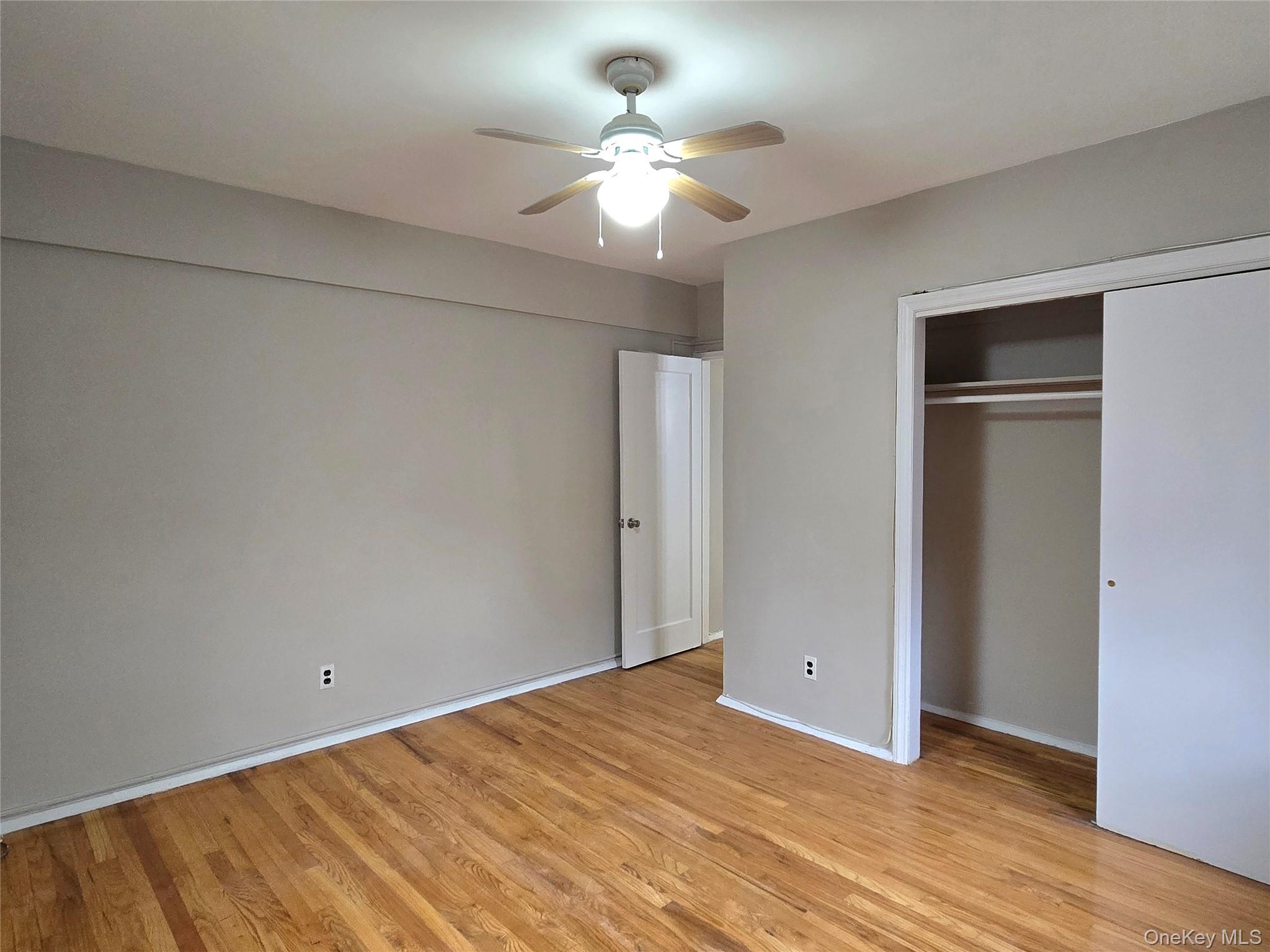 138-18 28th Road, Unit 2F Queens, NY 11354 - Photo 9 of 13 a view of a room with a ceiling fan and a hardwood floor