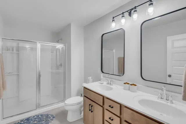 a bedroom with bed and a chandelier