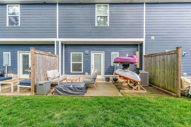 a view of a big house with a big yard and potted plants and large trees