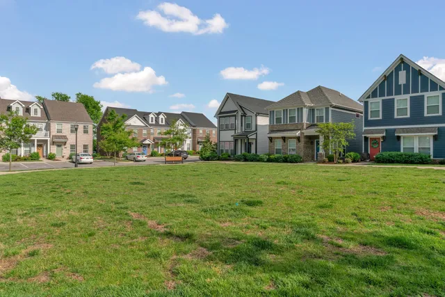 a view of a house with a yard and sitting area