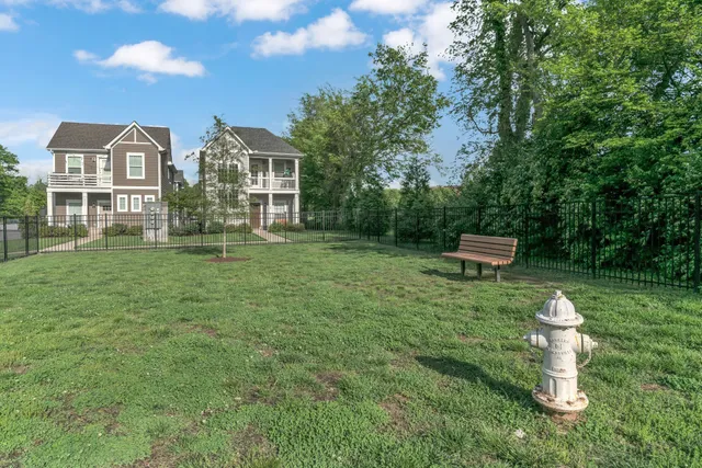 a view of a house with a yard and sitting area