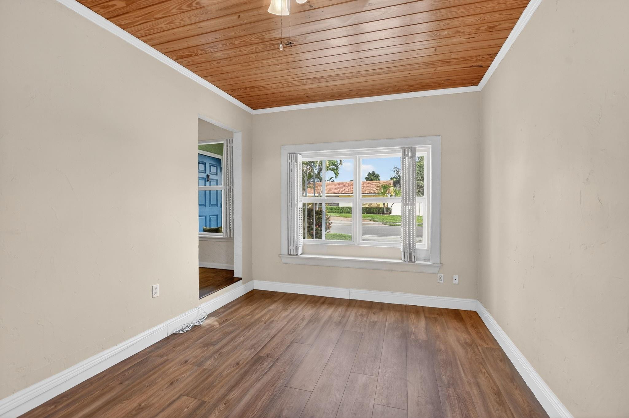 501 Northwest 54th Street Boca Raton, FL 33487 - Photo 12 of 44 an empty room with wooden floor and windows