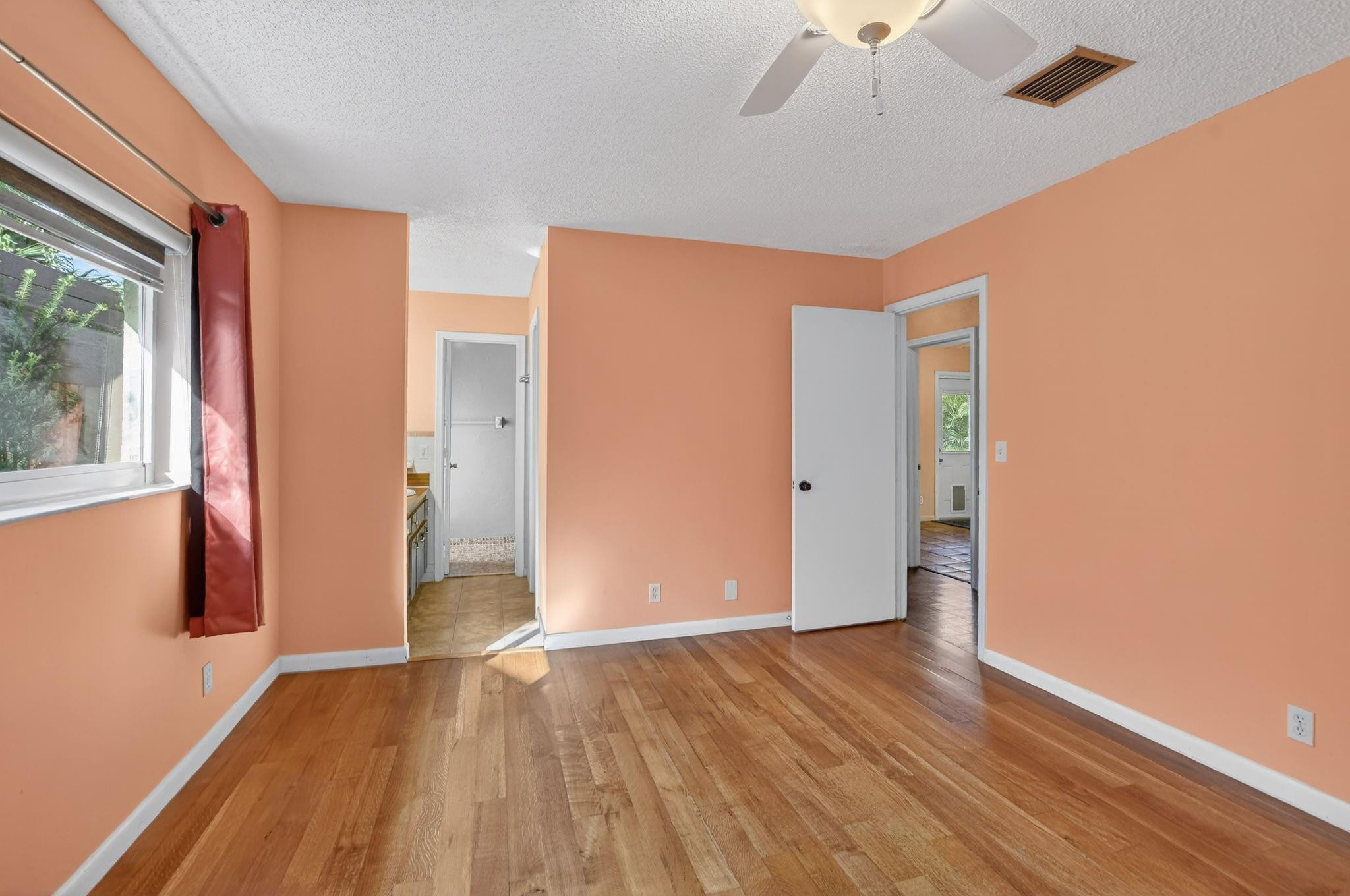 501 Northwest 54th Street Boca Raton, FL 33487 - Photo 19 of 44 a view of an empty room with wooden floor and a window