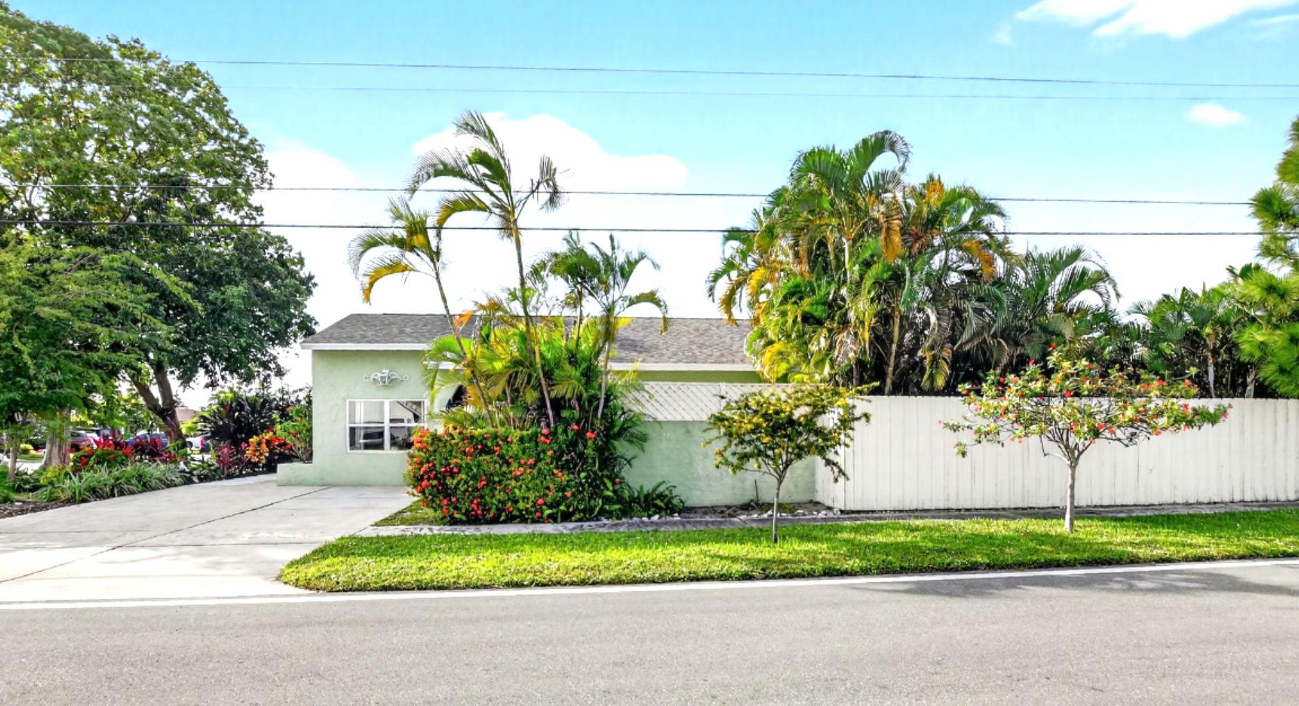 501 Northwest 54th Street Boca Raton, FL 33487 - Photo 2 of 44 a front view of a house with a yard and plant