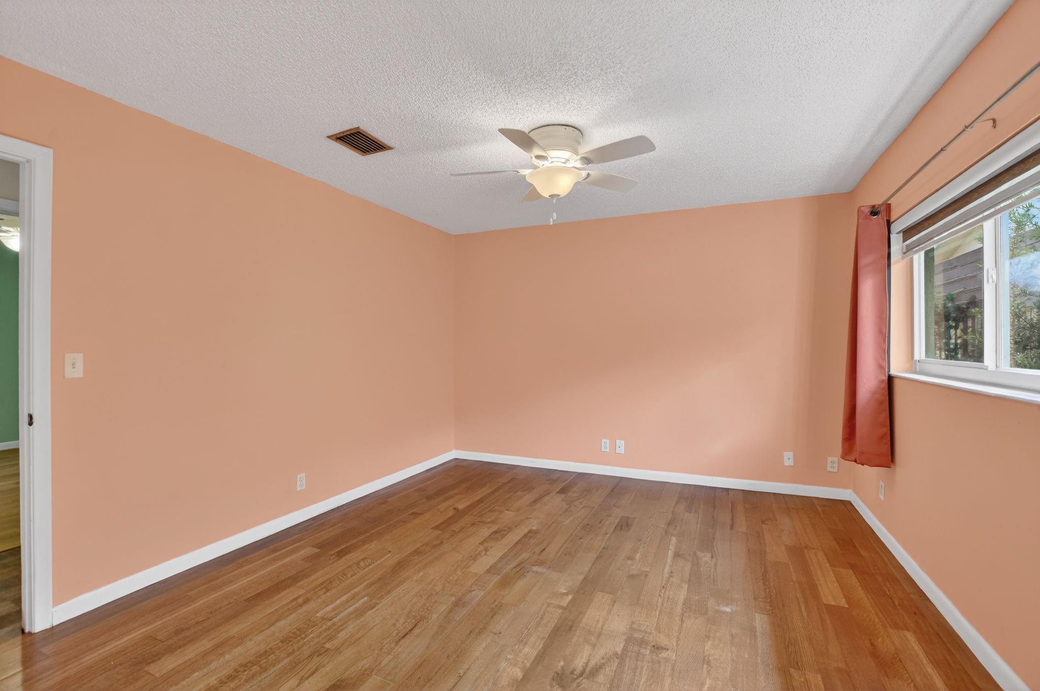 501 Northwest 54th Street Boca Raton, FL 33487 - Photo 21 of 44 a view of empty room with wooden floor and fan