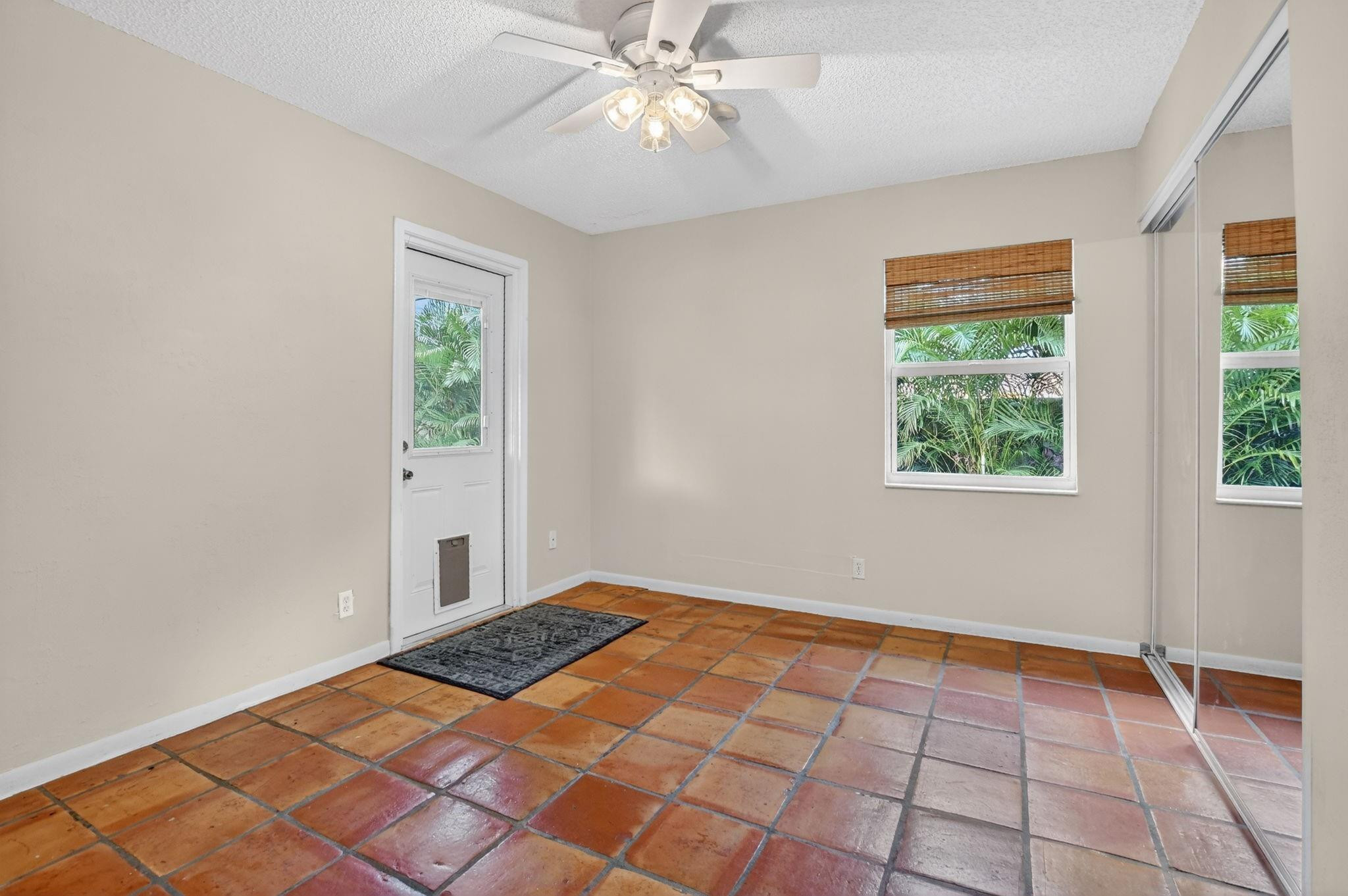 501 Northwest 54th Street Boca Raton, FL 33487 - Photo 26 of 44 a view of an empty room with window and chandelier fan