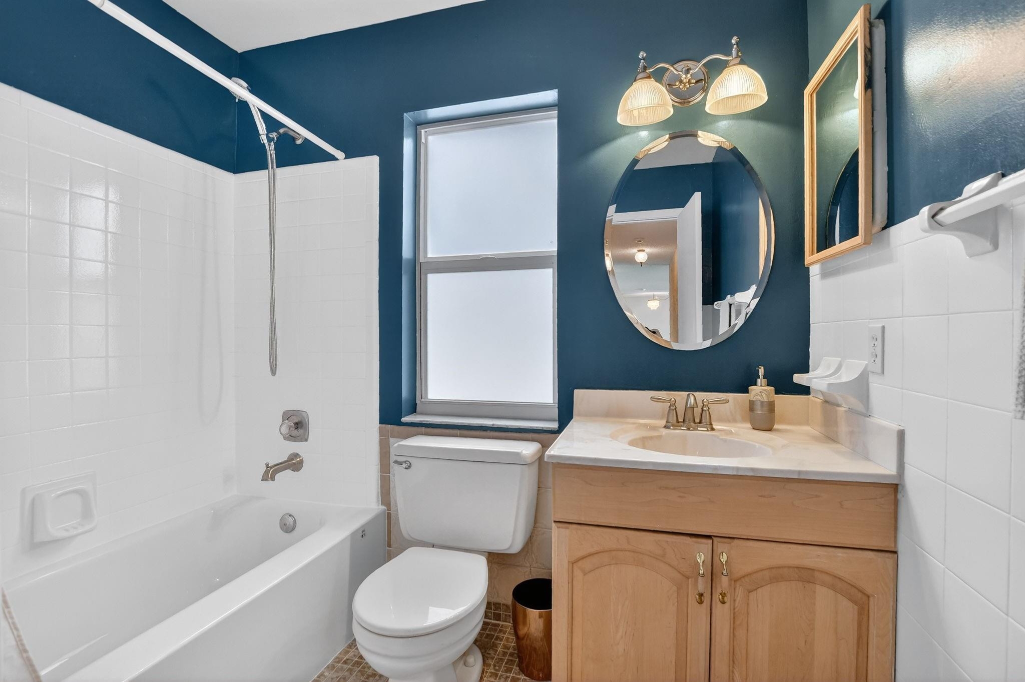 501 Northwest 54th Street Boca Raton, FL 33487 - Photo 28 of 44 a bathroom with a sink a toilet a mirror a vanity and shower