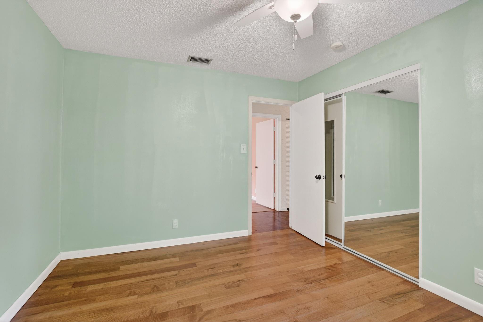 501 Northwest 54th Street Boca Raton, FL 33487 - Photo 30 of 44 a view of empty room with wooden floor and fan