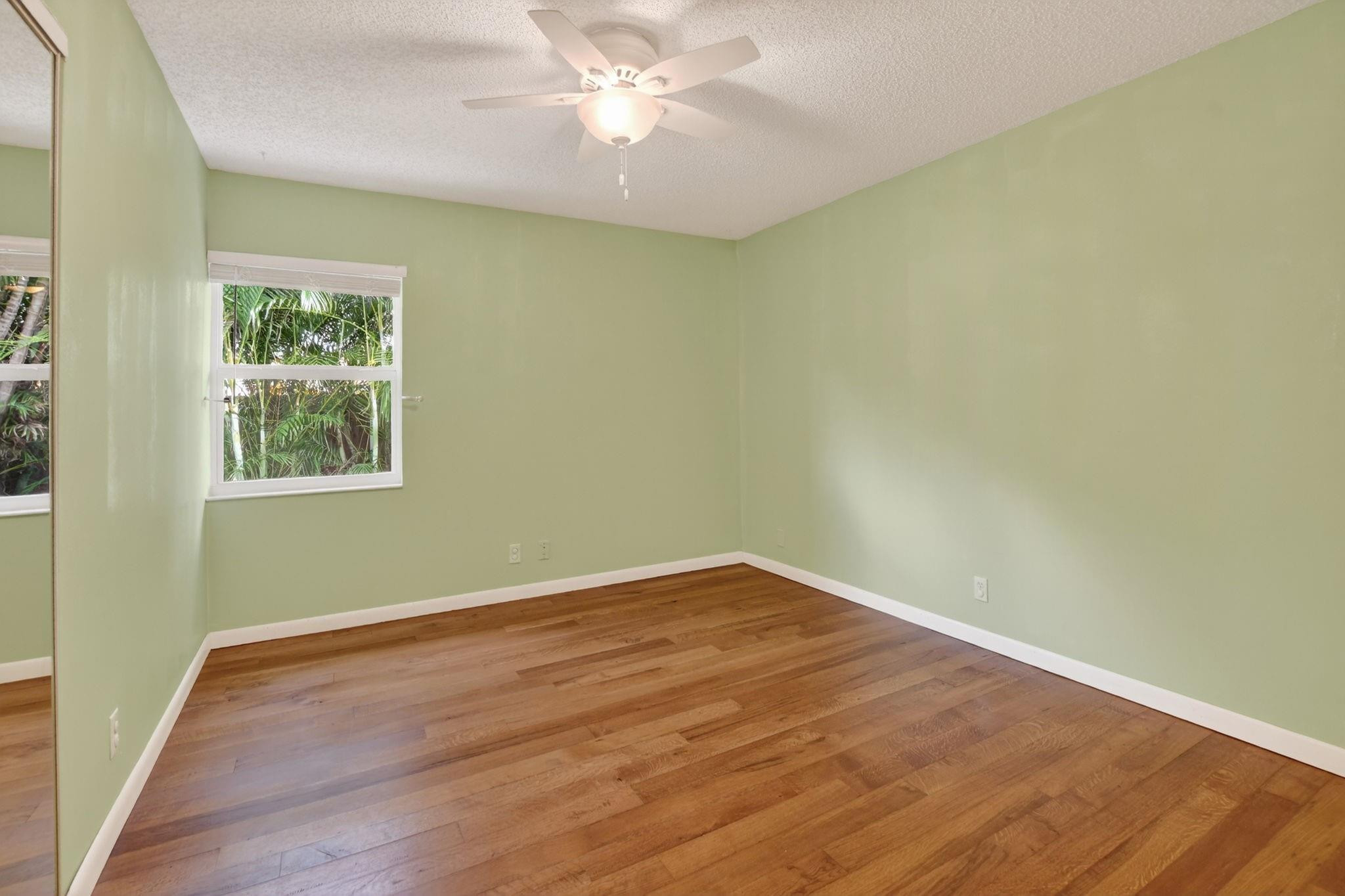 501 Northwest 54th Street Boca Raton, FL 33487 - Photo 31 of 44 an empty room with wooden floor and windows