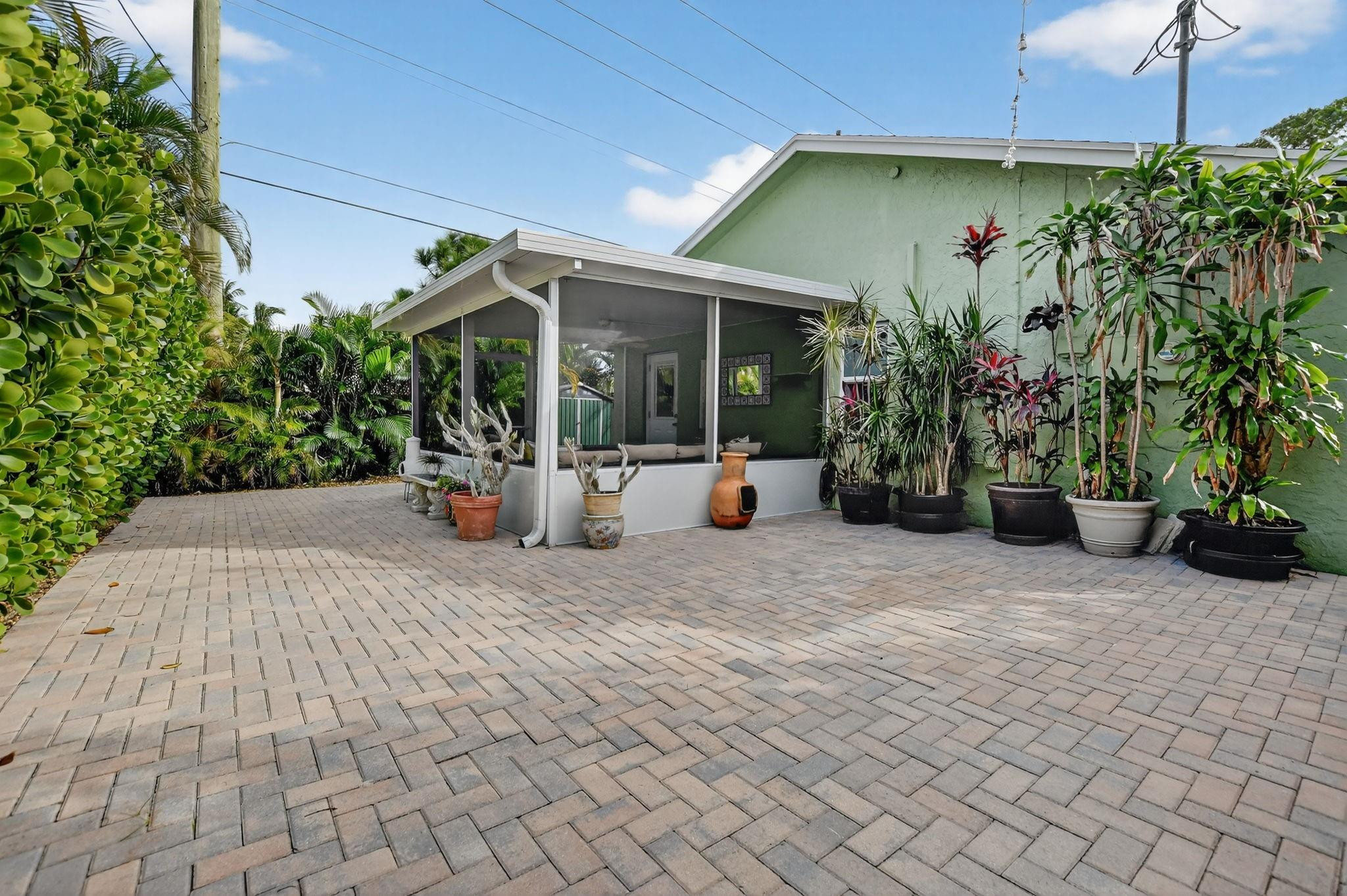 501 Northwest 54th Street Boca Raton, FL 33487 - Photo 34 of 44 a view of a patio with plants and chairs