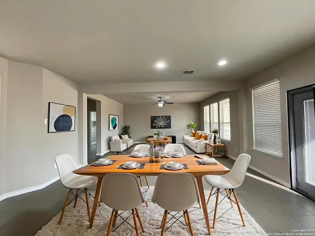 a view of a dining room with furniture and window