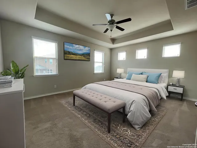 a bedroom with a large bed chandelier and a window