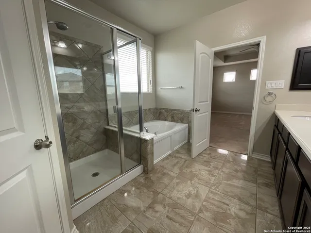 a bathroom with a shower and a sink