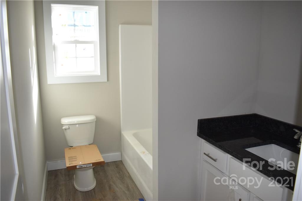2127 State Rd S-46-1474, Unit 4 Clover, SC 29710 - Photo 11 of 23 a bathroom with a toilet a sink and a window