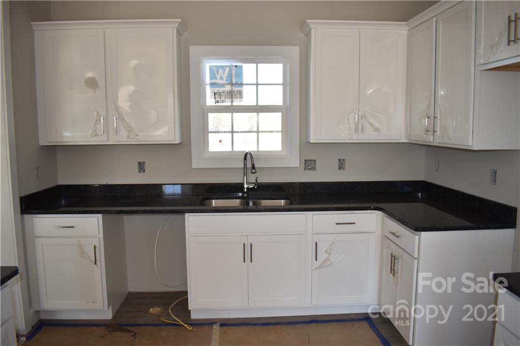 2127 State Rd S-46-1474, Unit 4 Clover, SC 29710 - Photo 4 of 23 a kitchen with white cabinets and sink