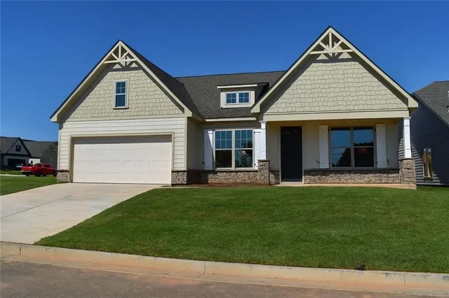 a front view of a house with a garden and porch
