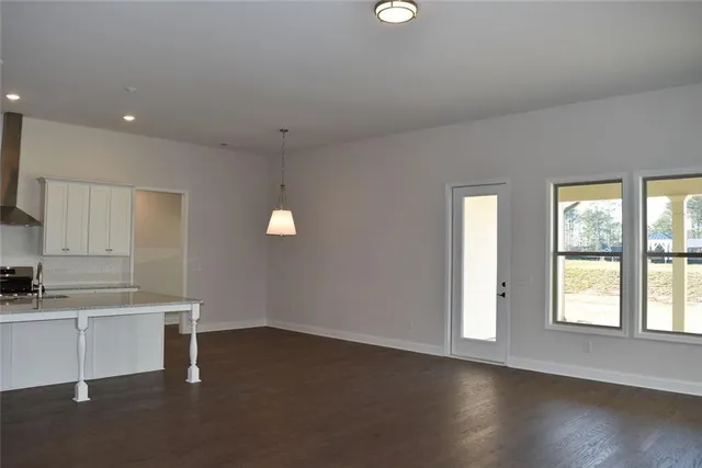 a kitchen with stainless steel appliances granite countertop a sink a stove and a refrigerator