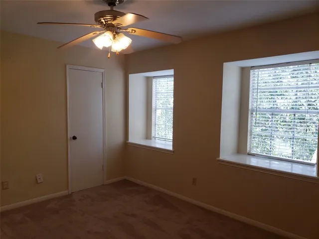 a view of room with window and ceiling fan
