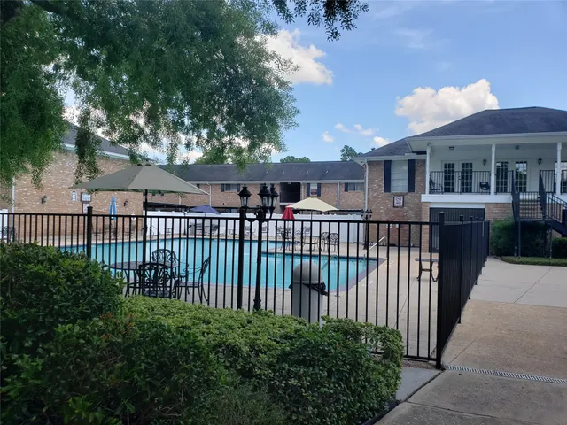 a view of a house with a small yard and wooden fence