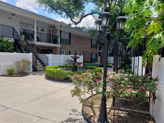 a front view of a house with a yard and a garden