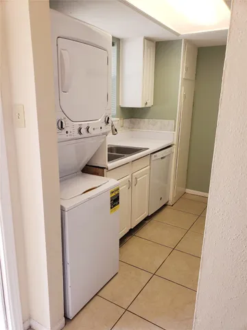 a utility room with cabinets washer and dryer