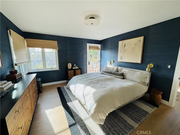a bathroom with a granite countertop sink a mirror and a bathtub