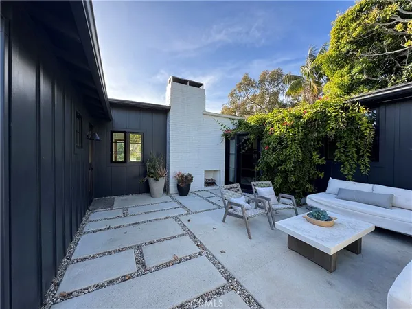 a view of a patio with a table and chairs and potted plants